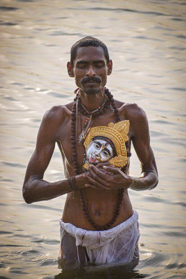 Hombre rezando en el rio